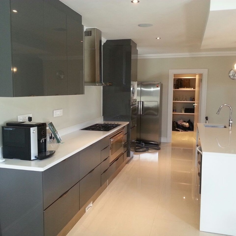Kitchen with grey cabinets and walk-in pantry
